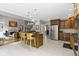 Open concept kitchen featuring stainless steel appliances, center island with barstool seating, and tile flooring at 7744 Preservation Dr, Indianapolis, IN 46278