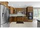 Well-equipped kitchen with wood cabinets, granite countertops, and stainless steel appliances at 7744 Preservation Dr, Indianapolis, IN 46278