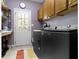 Laundry room with ample cabinet space, folding table, and modern washer and dryer at 7744 Preservation Dr, Indianapolis, IN 46278
