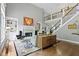 Spacious living room featuring a fireplace, hardwood floors, and staircase at 7744 Preservation Dr, Indianapolis, IN 46278