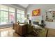 Comfortable living room with large windows, fireplace, and hardwood floors at 7744 Preservation Dr, Indianapolis, IN 46278