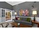 Bright living room with modern art, plush seating, and wainscotting for an elegant feel at 7744 Preservation Dr, Indianapolis, IN 46278