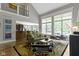 Open-concept living room with large windows, plush seating, and hardwood floors at 7744 Preservation Dr, Indianapolis, IN 46278