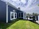 Backyard view of siding, covered porch, and a deck with furniture overlooking the lake at 7838 Chesapeake E Dr, Indianapolis, IN 46236