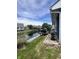 This backyard boasts a deck for outdoor seating, lush landscaping, and water frontage at 7838 Chesapeake E Dr, Indianapolis, IN 46236