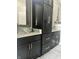 Contemporary bathroom featuring double vanities with granite countertops, vessel sinks, and black cabinetry at 7838 Chesapeake E Dr, Indianapolis, IN 46236