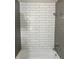 This bathroom features a shower with white subway tile, a showerhead, and chrome hardware at 7838 Chesapeake E Dr, Indianapolis, IN 46236