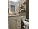 Stylish bathroom features a vanity with a granite countertop, a toilet, and decorative floating shelves at 7838 Chesapeake E Dr, Indianapolis, IN 46236