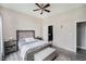 Comfortable bedroom featuring neutral colors, a ceiling fan, and opening to Primary bath at 7838 Chesapeake E Dr, Indianapolis, IN 46236