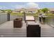 Relaxing deck with comfortable seating and a grill, overlooking a serene lake at 7838 Chesapeake E Dr, Indianapolis, IN 46236