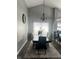 Elegant dining room features a modern chandelier, neutral rug, and bright natural light through the window at 7838 Chesapeake E Dr, Indianapolis, IN 46236