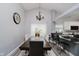Open dining room featuring a stylish chandelier, adjacent to the kitchen counter with seating at 7838 Chesapeake E Dr, Indianapolis, IN 46236