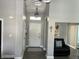 Inviting entryway with gray walls, luxury vinyl flooring, and a white door at 7838 Chesapeake E Dr, Indianapolis, IN 46236