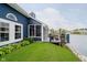 Scenic backyard view of home with deck, landscaping, and lake access at 7838 Chesapeake E Dr, Indianapolis, IN 46236