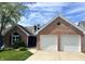 Beautiful brick home with a well-kept lawn and an attached two-car garage at 7838 Chesapeake E Dr, Indianapolis, IN 46236