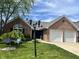 Charming brick home featuring an attached two-car garage and well-manicured front lawn at 7838 Chesapeake E Dr, Indianapolis, IN 46236