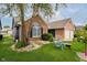 Attractive brick home with well-manicured lawn, mature trees, and inviting curb appeal at 7838 Chesapeake E Dr, Indianapolis, IN 46236