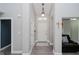 Inviting hallway with neutral paint, hardwood floors, and decorative lighting at 7838 Chesapeake E Dr, Indianapolis, IN 46236
