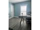 Bright home office features a modern desk, rolling chair, and natural light from the window at 7838 Chesapeake E Dr, Indianapolis, IN 46236
