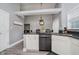 Open kitchen with granite countertops and stainless steel appliances adjoining to the dining area at 7838 Chesapeake E Dr, Indianapolis, IN 46236