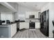 Well-lit kitchen featuring stainless steel appliances and white cabinets with modern finishes at 7838 Chesapeake E Dr, Indianapolis, IN 46236