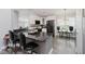 Modern kitchen with white cabinets, black appliances, and a breakfast bar at 7838 Chesapeake E Dr, Indianapolis, IN 46236