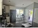 Spacious kitchen with white cabinets, a peninsula with seating, and a bright, airy dining area at 7838 Chesapeake E Dr, Indianapolis, IN 46236