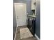 Well-organized laundry room with a washer and dryer, cabinets, and gray walls at 7838 Chesapeake E Dr, Indianapolis, IN 46236