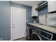 Laundry room featuring front loading washer and dryer set with folding countertop at 7838 Chesapeake E Dr, Indianapolis, IN 46236
