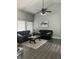Bright living room with plush seating, a modern ceiling fan, and sleek hardwood floors at 7838 Chesapeake E Dr, Indianapolis, IN 46236
