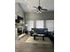 Inviting living room featuring a fireplace, comfortable sofas, and a stylish ceiling fan at 7838 Chesapeake E Dr, Indianapolis, IN 46236