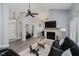 Bright living room featuring a stone fireplace, ceiling fan, and comfortable seating at 7838 Chesapeake E Dr, Indianapolis, IN 46236