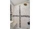 Walk-in shower featuring marble-style tile and a contrasting decorative accent stripe at 7838 Chesapeake E Dr, Indianapolis, IN 46236