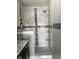 Modern shower with decorative tile accents, a rainfall showerhead, and convenient built-in shelving at 7838 Chesapeake E Dr, Indianapolis, IN 46236