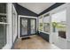 Comfortable sunroom featuring tile flooring and access to the rear porch at 7838 Chesapeake E Dr, Indianapolis, IN 46236