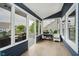 Inviting sunroom with tile floor, large windows, and adjacent deck overlooking the water at 7838 Chesapeake E Dr, Indianapolis, IN 46236
