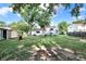 Expansive backyard featuring lush greenery, mature trees, playset, and ample space for outdoor activities at 7915 Broadview Dr, Indianapolis, IN 46227
