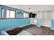 Bedroom featuring blue walls, wood-look flooring, and natural light from windows with view to the outside at 7915 Broadview Dr, Indianapolis, IN 46227