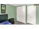 Bedroom featuring green walls, a bed, closet, and dresser at 7915 Broadview Dr, Indianapolis, IN 46227