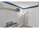 A view of a simple room with a colorful floor lamp, door, and musical keyboard at 7915 Broadview Dr, Indianapolis, IN 46227