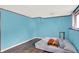 A blue bedroom features an air mattress on wood floors and light from multiple windows at 7915 Broadview Dr, Indianapolis, IN 46227