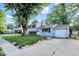 Inviting two-story home with light blue siding, black shutters, attached garage, and a concrete driveway at 7915 Broadview Dr, Indianapolis, IN 46227