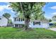 Charming two-story home featuring light blue siding, black shutters, and a well-manicured lawn at 7915 Broadview Dr, Indianapolis, IN 46227