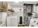 Utility room equipped with washing machine, dryer, water heater, and storage shelves at 7915 Broadview Dr, Indianapolis, IN 46227