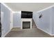 Inviting living room with a fireplace, television, carpeted staircase, and neutral walls at 7915 Broadview Dr, Indianapolis, IN 46227