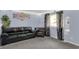 Cozy living room featuring a black leather sofa, neutral carpet, and natural light from the window at 7915 Broadview Dr, Indianapolis, IN 46227