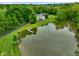 Aerial view of the home, outbuilding and dock on the pond at 8000 Mcwhorter Rd, Martinsville, IN 46151