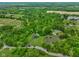 An expansive aerial shot captures the property, revealing a charming pond and verdant natural surroundings at 8000 Mcwhorter Rd, Martinsville, IN 46151