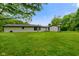 Spacious backyard with green lawn, surrounded by mature trees at 8000 Mcwhorter Rd, Martinsville, IN 46151