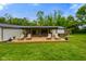 Expansive backyard featuring a wooden deck, lounge chairs, and lush green grass at 8000 Mcwhorter Rd, Martinsville, IN 46151
